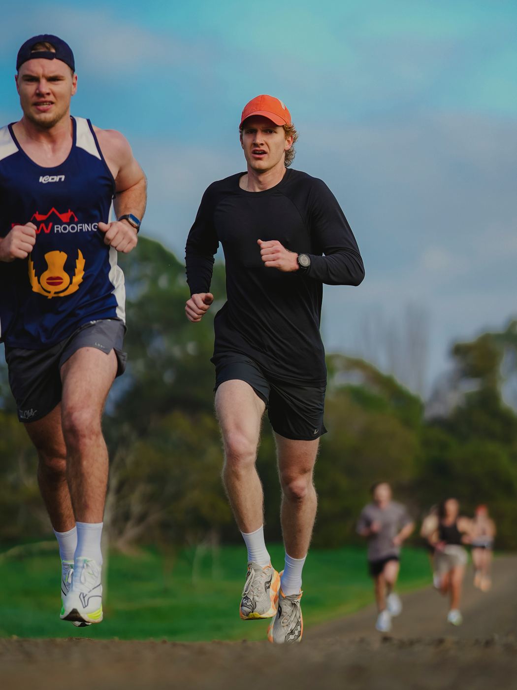 Luke running alongside an athlete he coaches