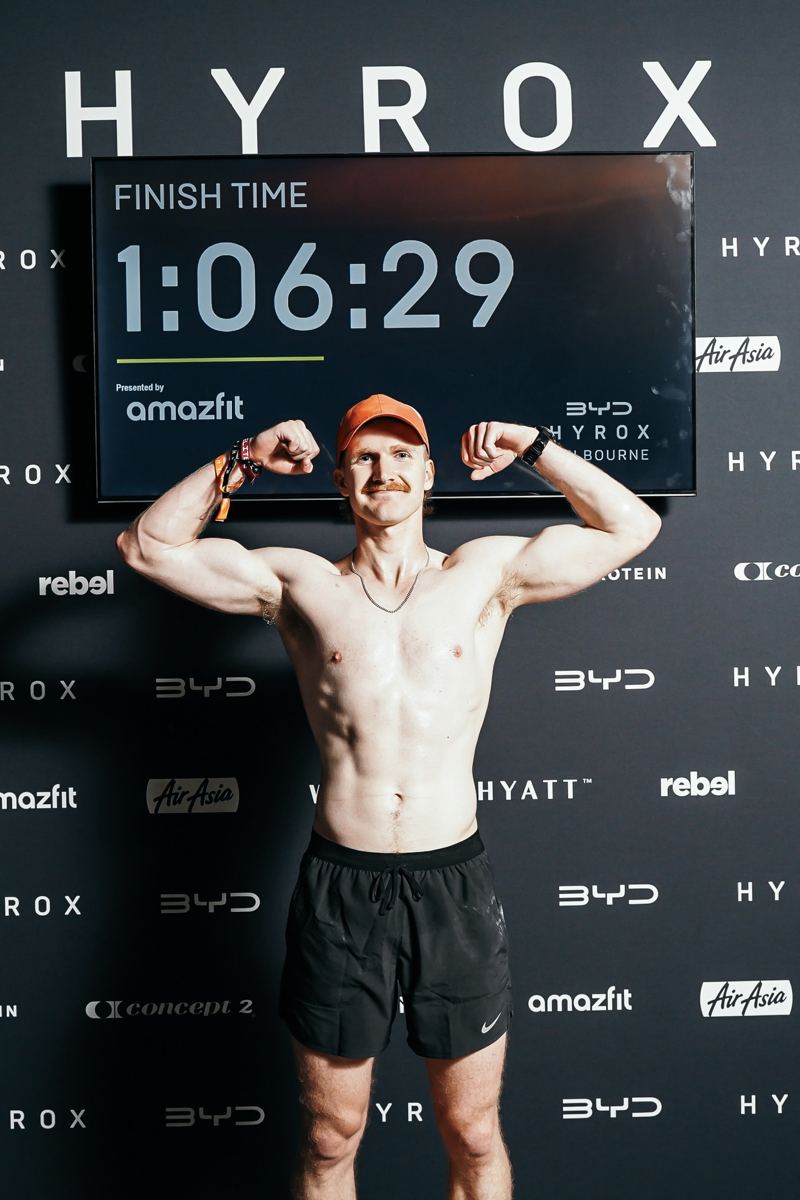 Luke at the finish wall with a time of 1:06:29