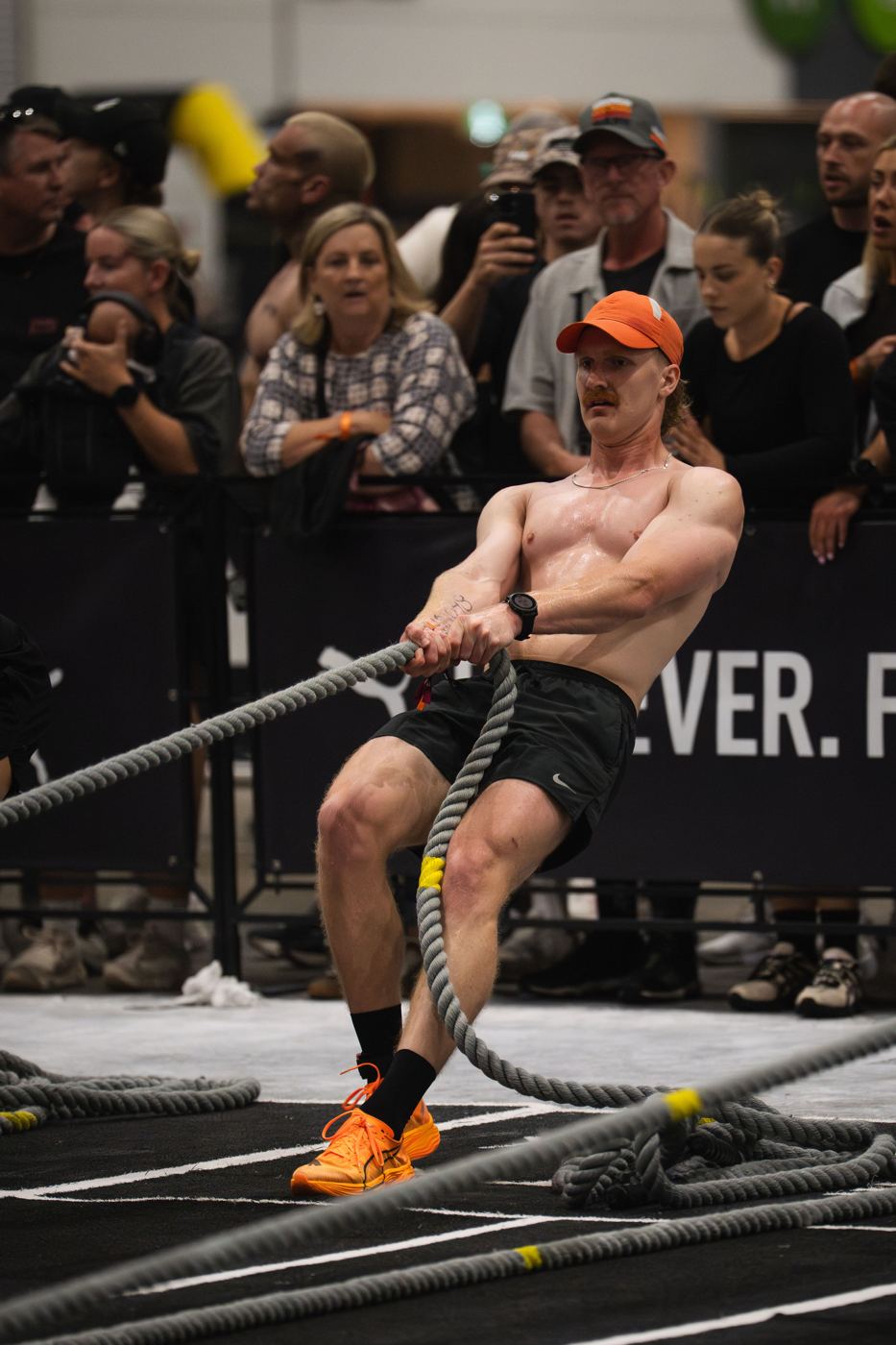 Luke pulling the sled in front of a crowd at a Hyrox race