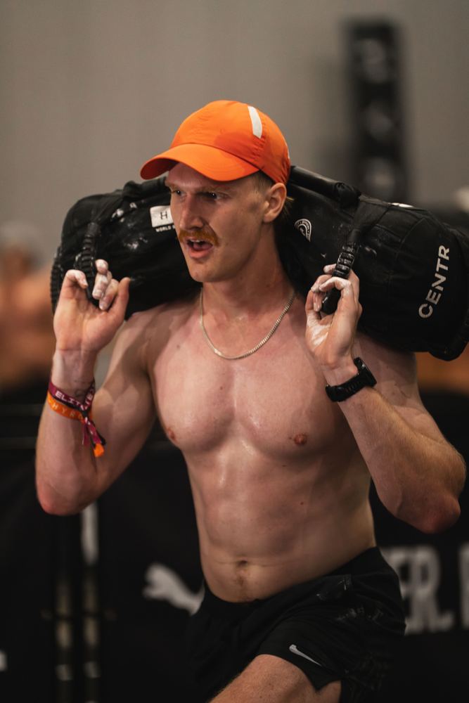 Luke carrying a sandbag during a race
